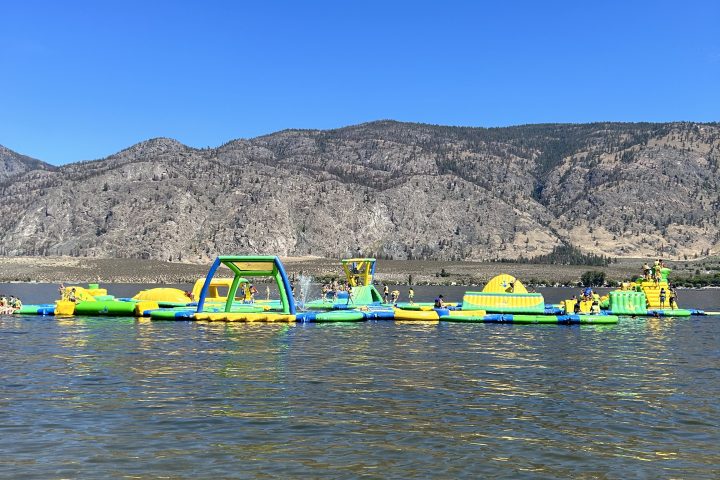 a colorful kite sitting on top of a beach