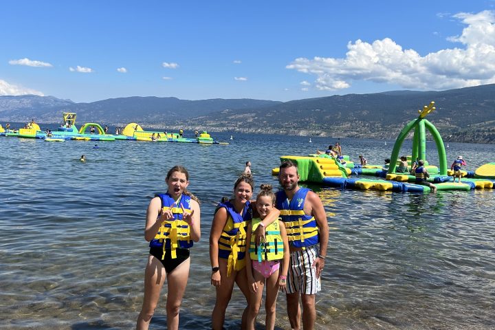 a group of people standing on top of a sandy beach