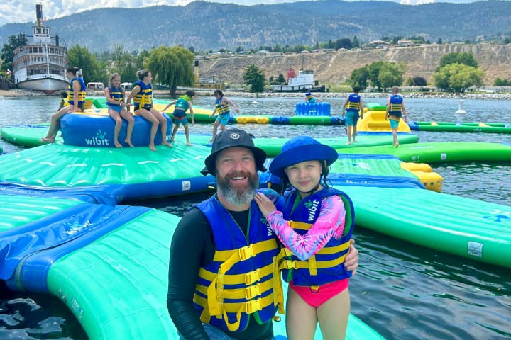 a person in a green boat on a body of water