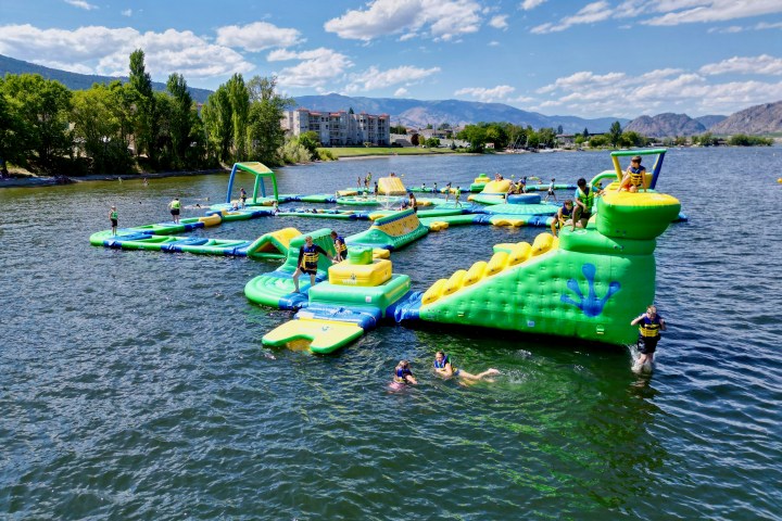 a group of people in a small boat in a body of water